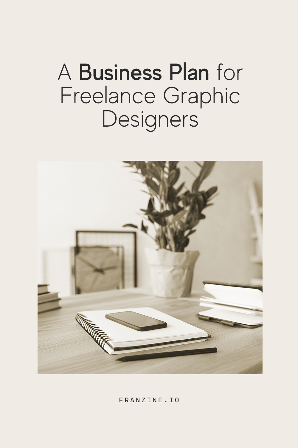 A desk photo with the text "A Business Plan for Freelance Graphic Designers" 